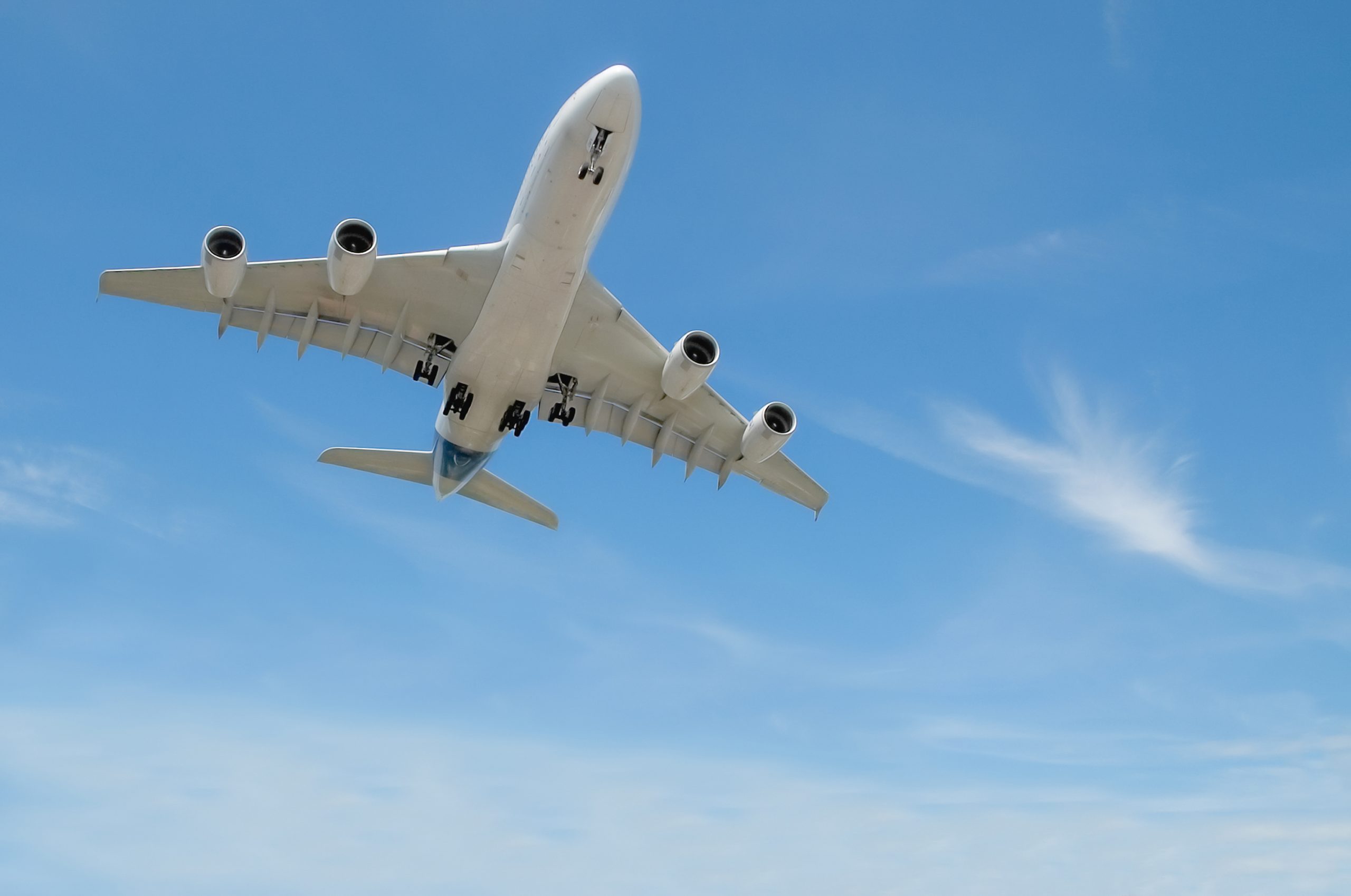 large jet aircraft on landing approach in a blue cloudy sky