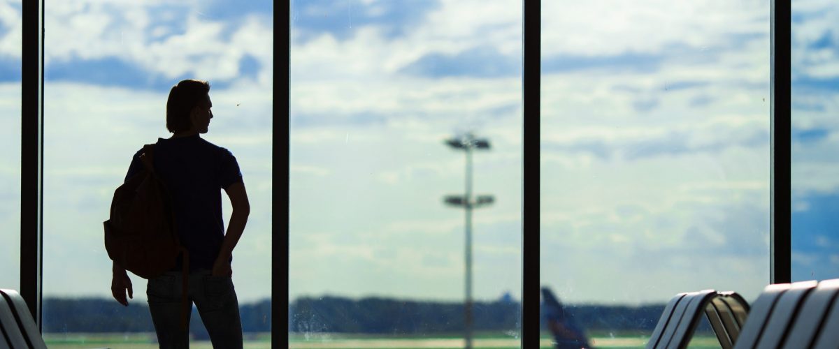 Silhouette of a man waiting to board a flight